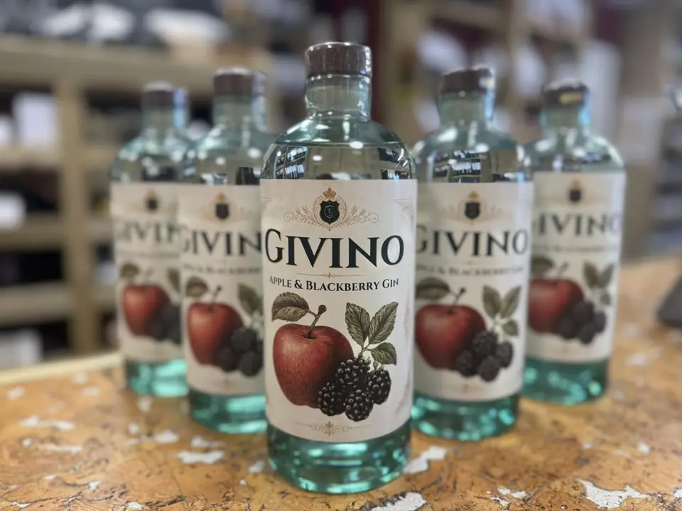 Bottles of Givino apple and blackberry gin lined up on a counter