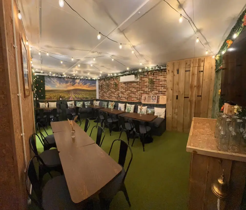 The long tasting room at Givino in Frome, set with tables under string lights