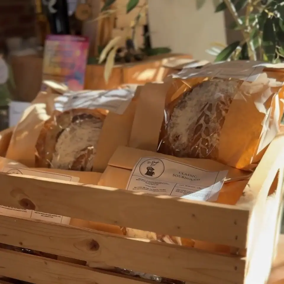 Loaves of bread in a wooden crate at The Little Shop of Olive Oils