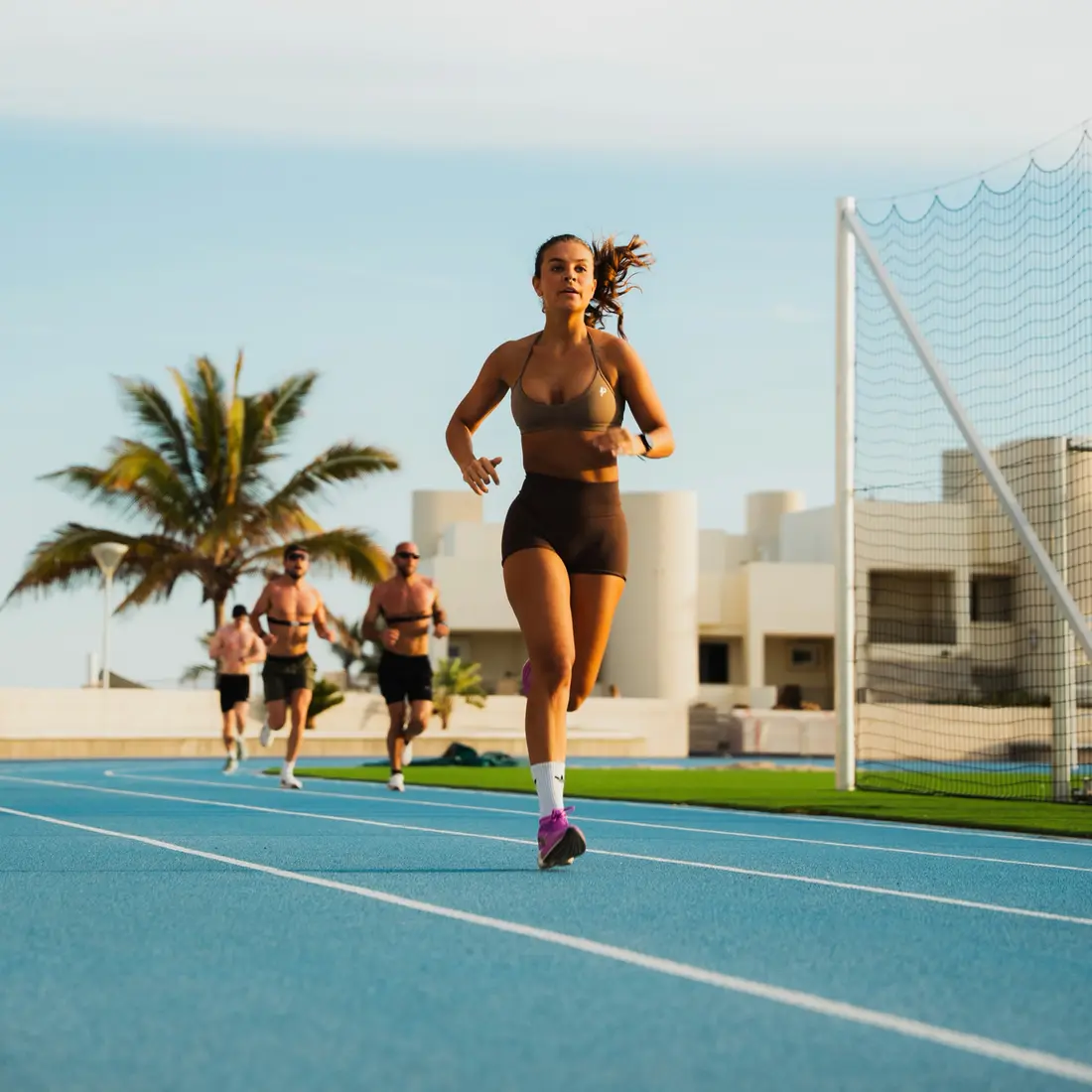 A Powerlete athlete running on an outdoor track