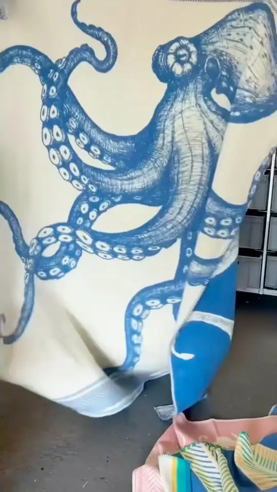 A close view of a blue octopus print on a Cream Cornwall textile