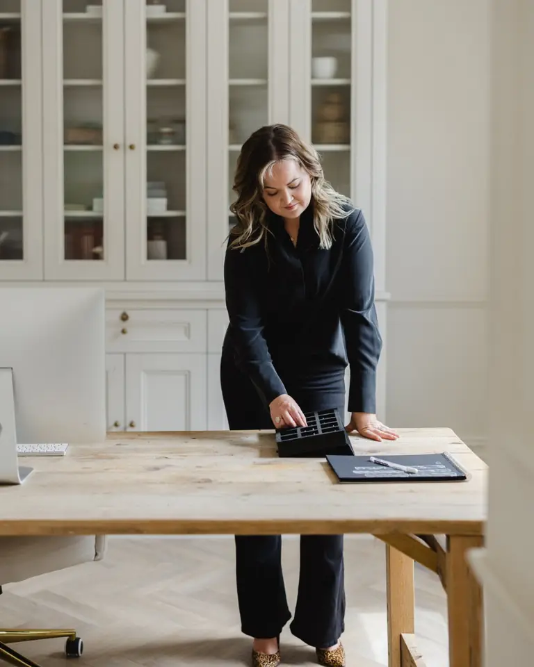 The Poppy Elder founder at a wooden desk in her studio
