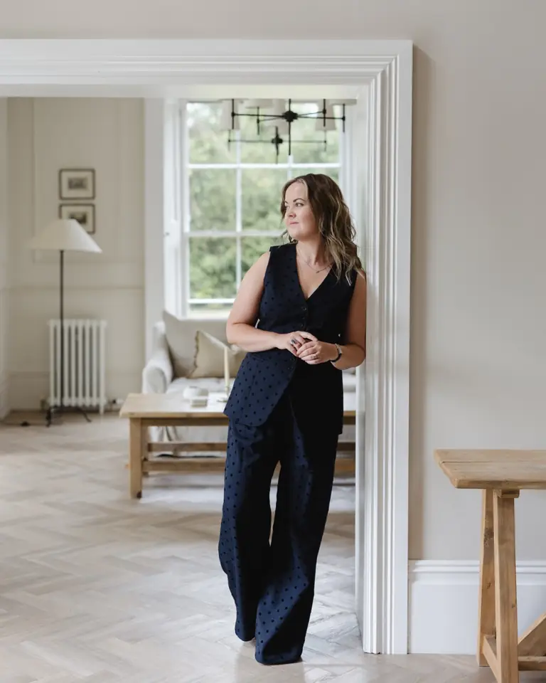 The Poppy Elder founder standing in a bright townhouse interior