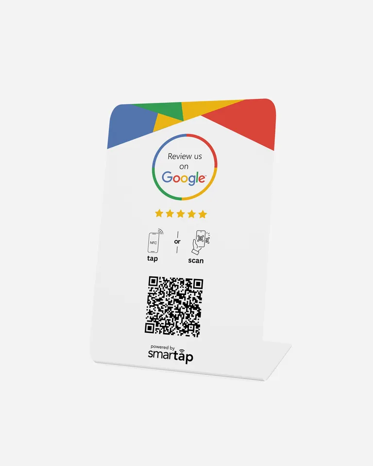 A white table stand printed "Review us on Google", with tap and scan instructions and a QR code