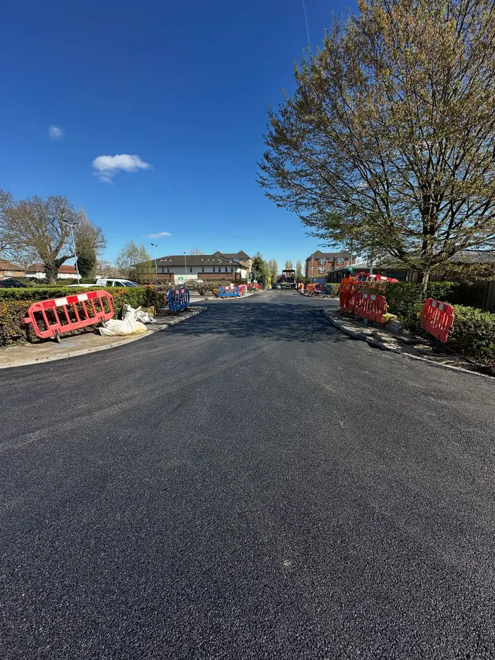 A freshly surfaced estate road lined with trees