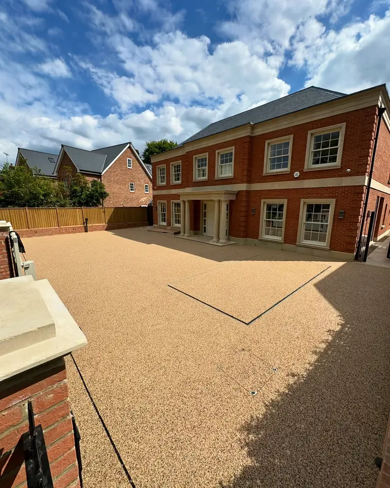 A resin-bound driveway in front of a new brick house