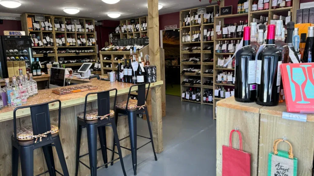 Inside the Givino wine shop and tasting room in Frome, shelves of wine behind the tasting bar