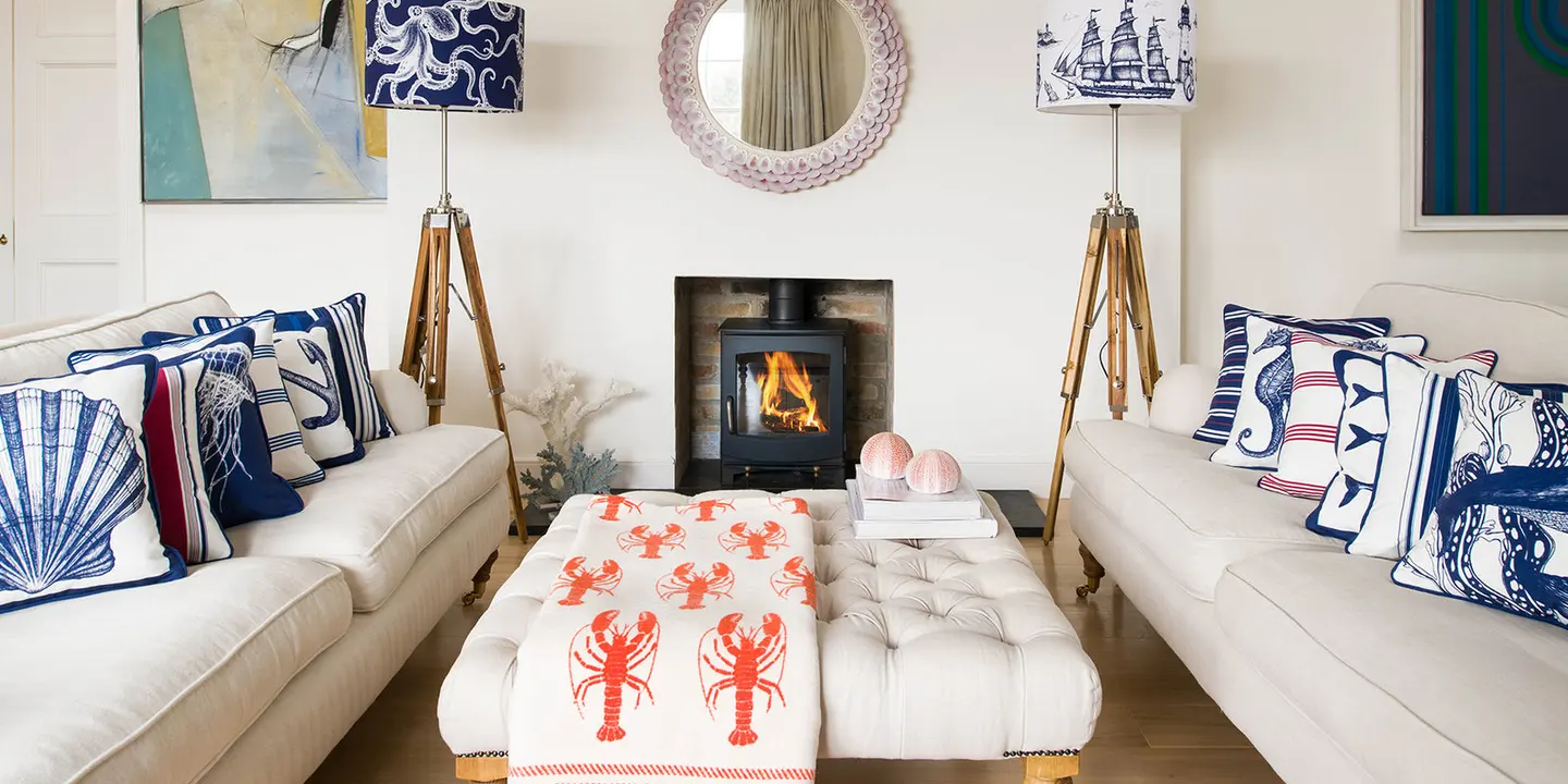 Cream Cornwall cushions, lampshades and a lobster throw styled in a Cornish living room