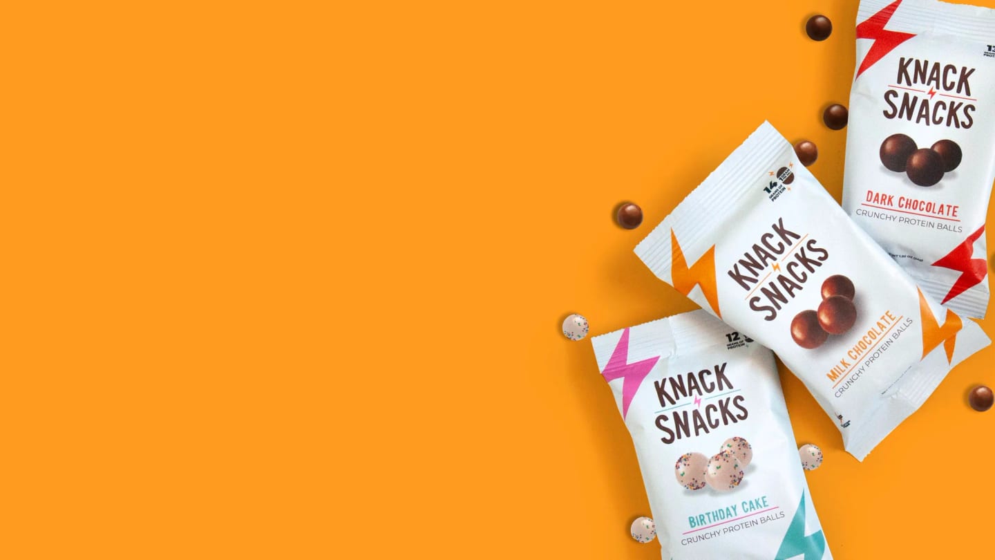 Knack Snacks chocolate protein snack packs on an orange ground