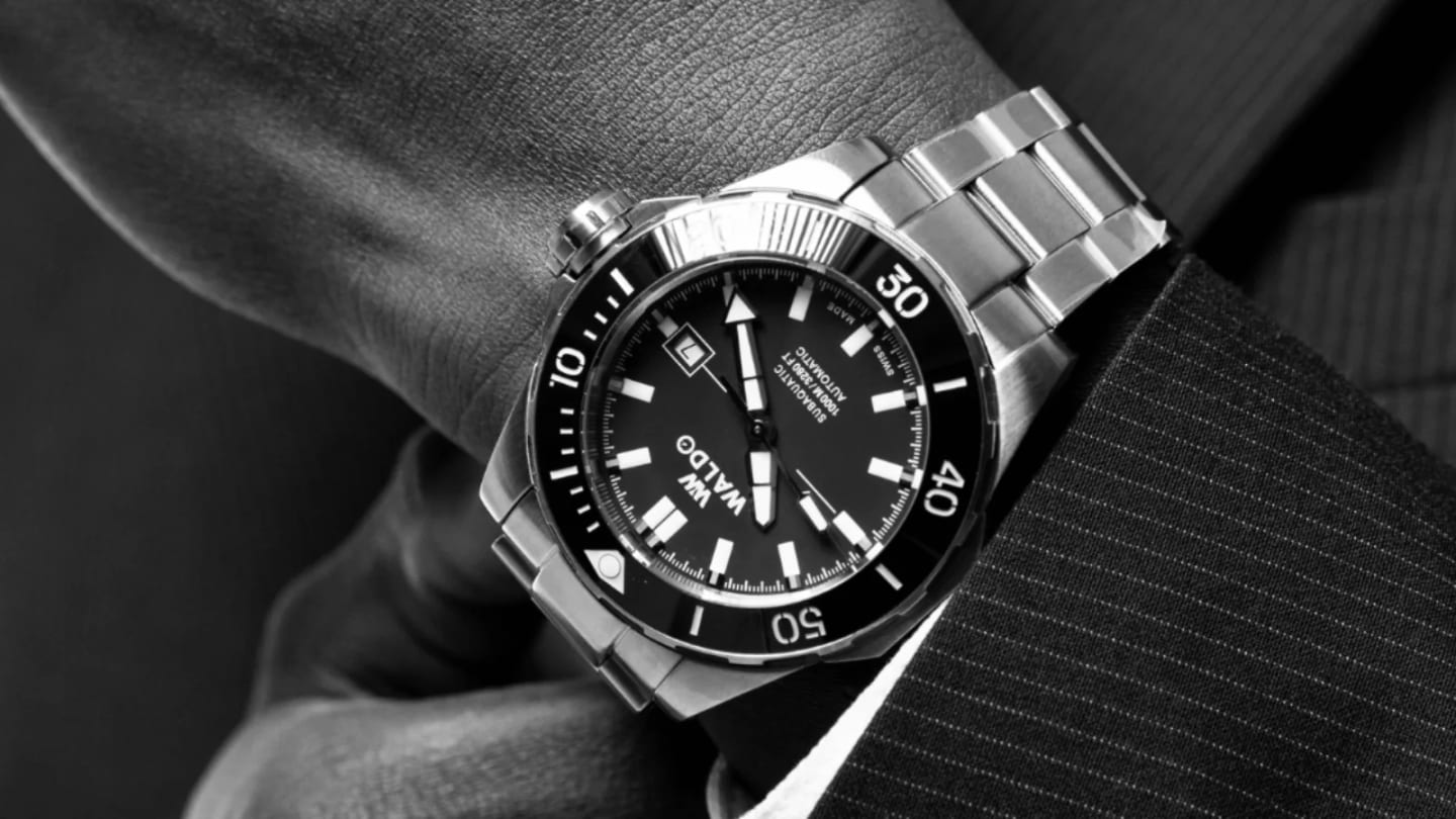 A Waldo dive watch worn on the wrist, close up